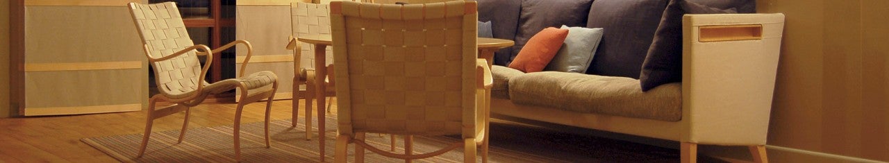 Living room with 3 wooden chairs and a sofa