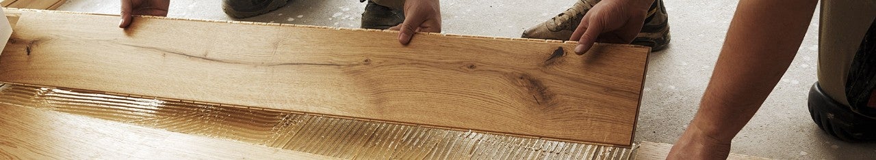 Hands lifting up a wooden plank
